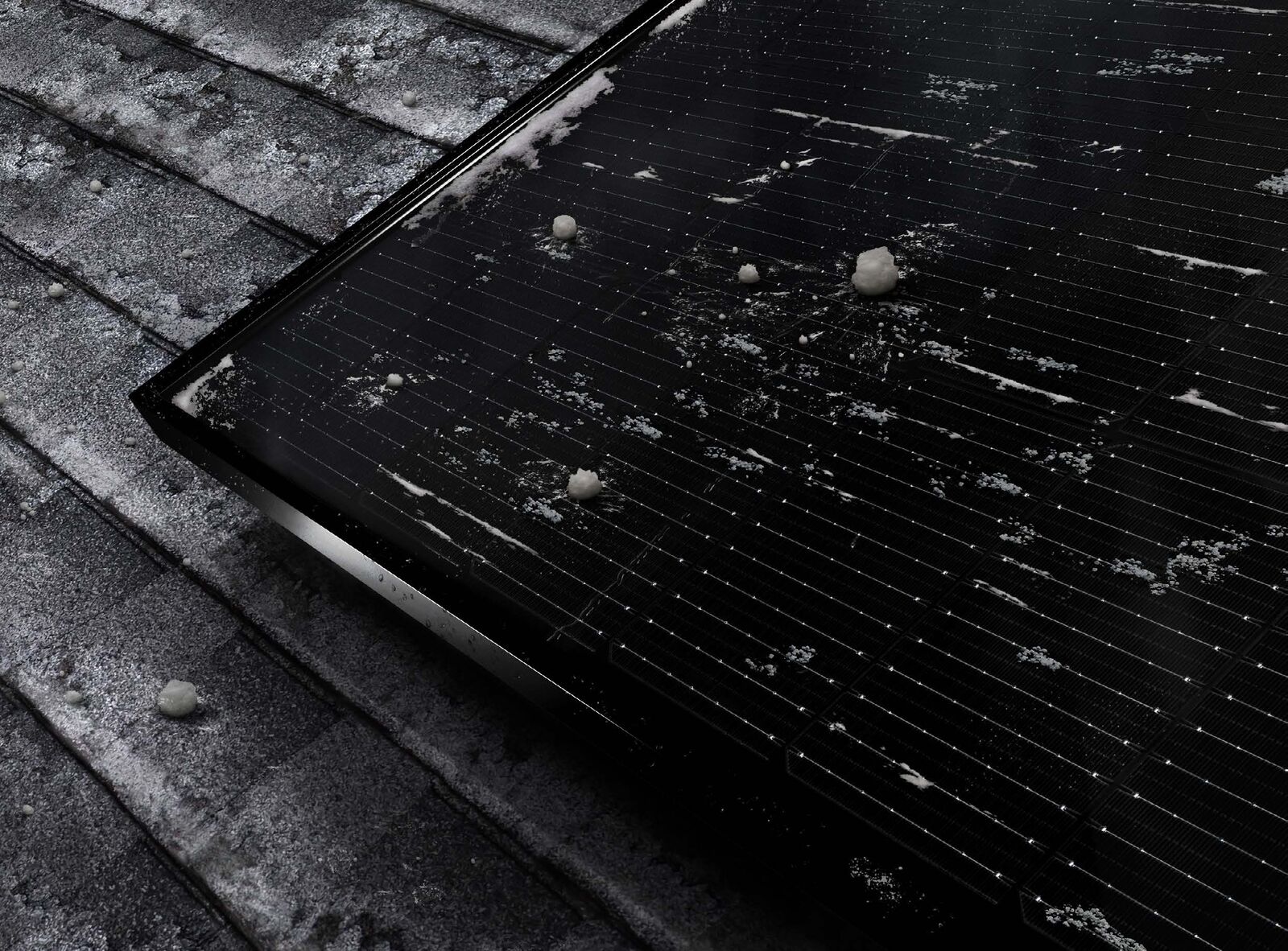 Close-up of a Q.TRON all-black panel shedding snow on a rooftop